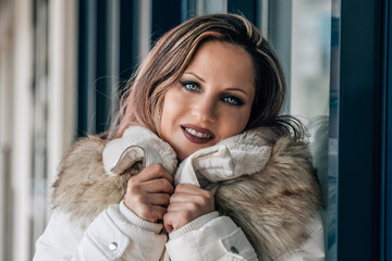 Portrait of young beautiful woman in winter clothes