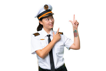 Airplane pilot Asian woman over isolated background pointing with the index finger a great idea