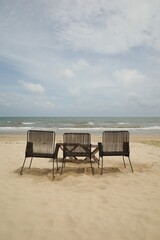 Third chairs on the sand beach on summer season