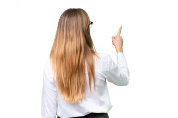 Young business caucasian woman over isolated background pointing back with the index finger