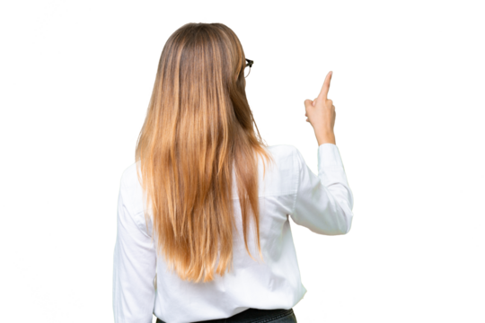 Young business caucasian woman over isolated background pointing back with the index finger - Powered by Adobe