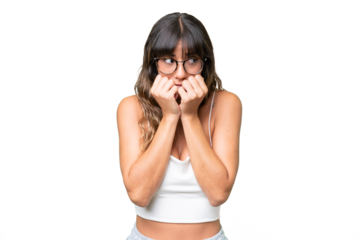 Young caucasian woman over isolated background nervous and scared putting hands to mouth