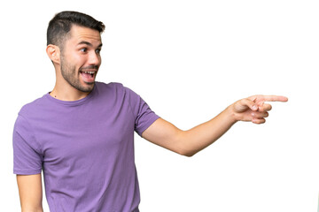 Young handsome caucasian man over isolated background pointing finger to the side and presenting a product