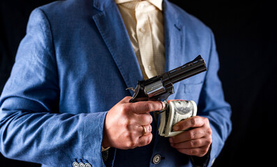 criminal police detective man holding revolver gun isolated on plain background.