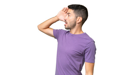 Fototapeta premium Young handsome caucasian man over isolated background with surprise expression while looking side