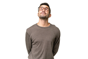 Young handsome caucasian man over isolated background and looking up