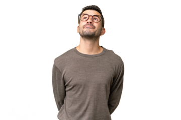 Young handsome caucasian man over isolated background and looking up