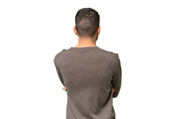 Young handsome caucasian man over isolated background in back position