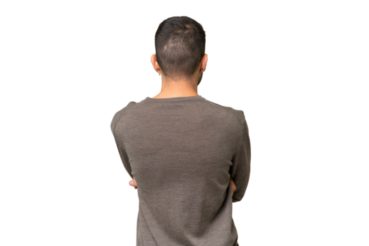 Young handsome caucasian man over isolated background in back position