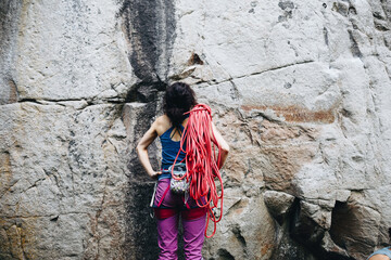 Strong female rock climber engaged in active sports, rock climbing and mountaineering. A woman...