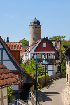 Germany, North Rhine-Westphalia, Warburg, Old town alley with city gate tower in background