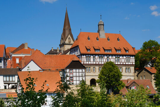 Germany, North Rhine-Westphalia, Warburg, Half-timbered town hall with church bell tower in background