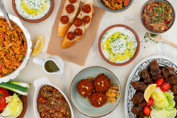 Turkish meze table, delicious meze appetizer combination setting, haydari, muhammara, kisir bulgur salad, roasted eggplant babagannush mezza tapas, traditional cigkofte bulgur balls top view photo