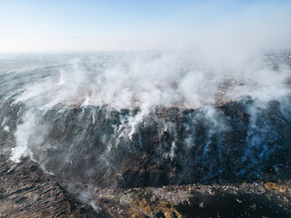 Aerial view of landfill with burning trash piles