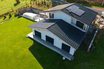 High angle view of solar photovoltaic panels on roof, alternative energy, saving resources and...