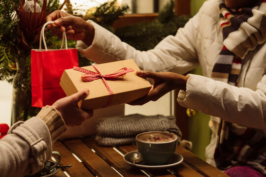 Women exchanging gifts with each other on Christmas