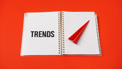 Global World Trends, Top New trends, forecasting. Word trends and red paper plane on red background.