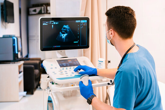 Doctor operating ultrasound machine at hospital