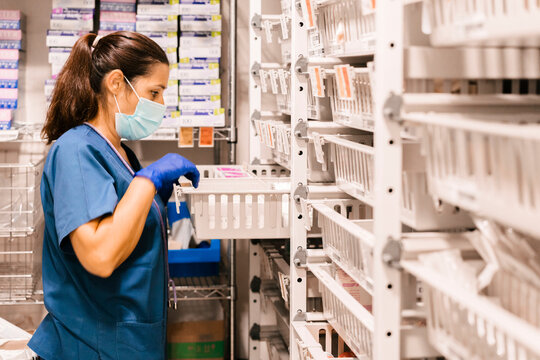 Nurse Wearing Protective Face Mask Checking Inventory At Hospital