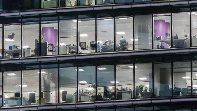 Close up view of office areas in a skyscraper. People working at late night in Moscow- City 