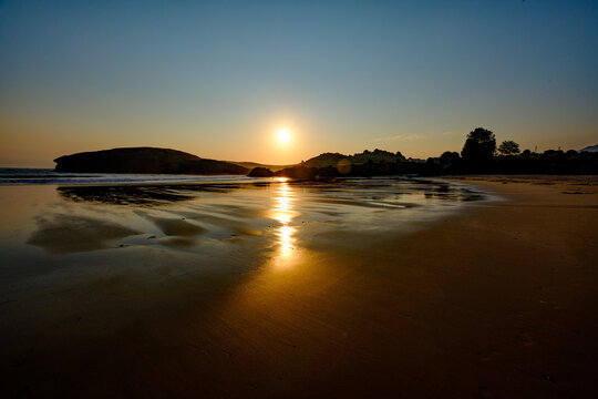 The smooth sand of Barru beach at low toide, in Asturias, Spain, at sunrise