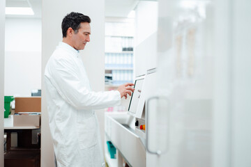 Pharmacist using monitor screen in pharmacy