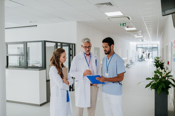 Doctors discussing something at hospital corridor.