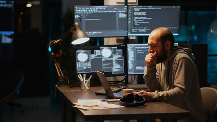 Sick programmer having sore throat and coughing in office, drinking cup of water and working on new app interface at night. Suffering from allergy infection or respiratory problem.