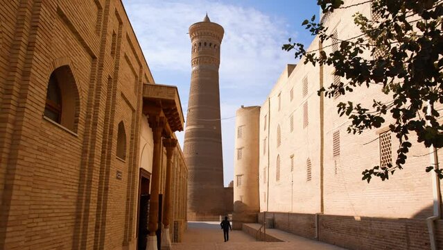 Autumn, 2022 - Bukhara, Uzbekistan - General plan. Old city of the ancient city. Tourist center of Bukhara. The camera moves to the ancient minaret in the Muslim religious center.