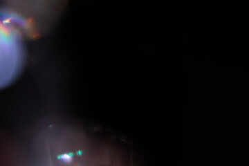 Blur colorful rainbow crystal light leaks on black background. Defocused abstract multicolored retro film lens flare bokeh analog photo overlay or screen filter effect. Glow Vintage prism colors