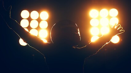 Silhouette of race car driver celebrating the win in a race against bright stadium lights. 100 FPS slow motion shot