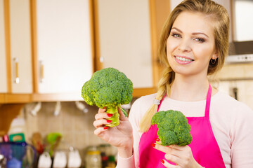 woman holding broccoli vegetable