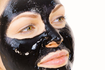 Woman with black peel off mask on face