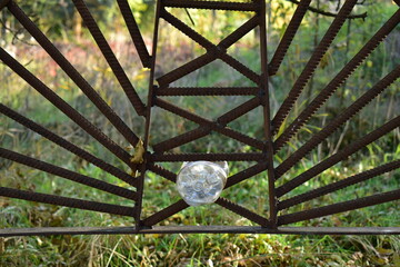 plastic bottle in a metal fence made of rebar