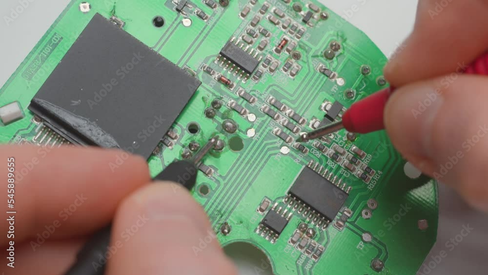 Poster man diagnosing a faulty circuit board with a multimeter. close up