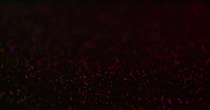 Bokeh sparkles background. Disco light. Defocused neon red blue purple orange color flicker flash glow motion on dark abstract texture with free space. Shot on RED Cinema Camera.