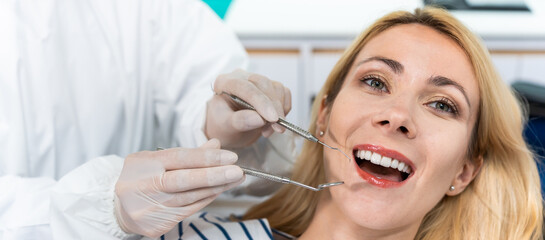 Portrait of Caucasian woman receive treatment from dentist at clinic. 