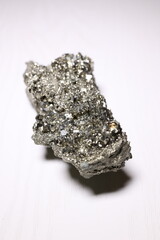 Pyrite crystal, or iron pyrite, on isolated white background, esoteric ore used to purify the...