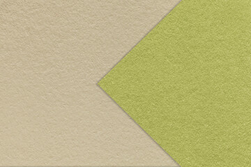 Fototapeta na wymiar Texture of craft beige paper background, half two colors with green arrow, macro. Kraft olive cardboard.