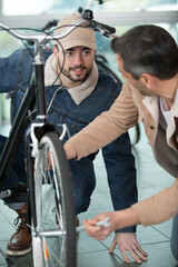 Fototapeta na wymiar bike mechanic repairs a bicycle outdoors