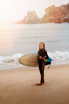 Small surfer with surfboard