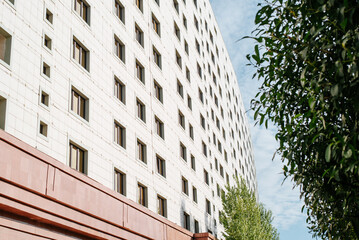 Apartment building exterior. Side view of the wall of the house with windows in the open air, perspective view