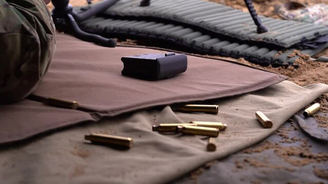 the cartridge case from the gun falls to the ground after the shot