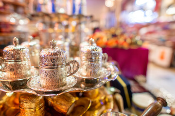 Silver tea cups in arabic style in a street market at night
