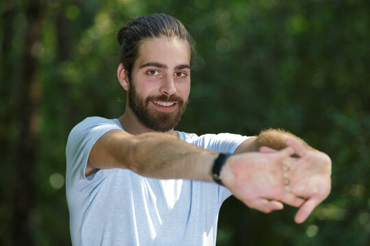 handsome fit man are stretching outdoor