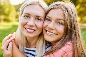 Obraz premium Happy daughter lovingly hugs her mother