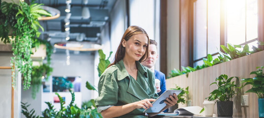 Coworking space, businessman and businesswoman at the office.