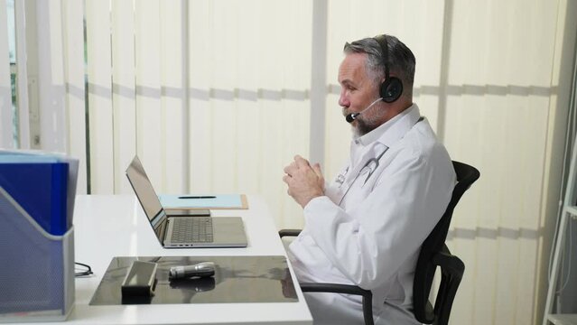Caucasian senior male medical doctor talk virtual online with patient. 