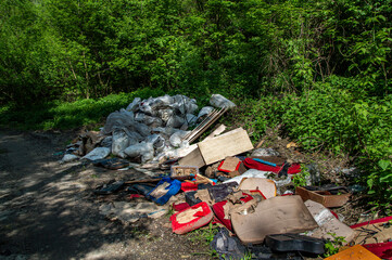 Unauthorized garbage dump near the road in a natural park area. Industrial waste. Garbage dump....