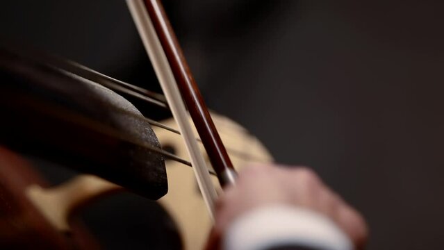 concert of the symphony orchestra close-up of the bow on the cello the concept of the development of musical taste classical music playing stringed classical musical instruments talented people in art